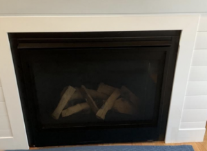 image showing wood trim touching the fireplace and creating a safety hazard